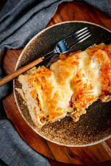 Stuffed pancake baked with cheese.