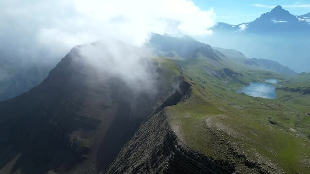 Grindelwald Bernese Alps mountain range in the clouds Switzerland aerial drone full hd 4k panoramic landscape
