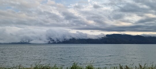 clouds falling over the meountains behind the lake Sevan in Armenia