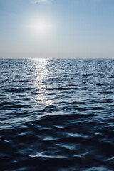 beautiful seascape. The blue sea goes into the horizon. reflection of the sun in the sea.vertical photo of the sea