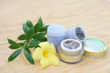 Bottles of homemade Thai herbal powder for smell to relieve dizzy symptoms, decorate with yellow...
