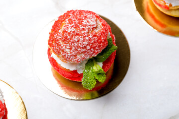 Shu cake. Custard dessert with creamy white cream, decorated with raspberries.