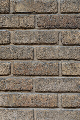 Dark brown brick old wall of a building, textured background