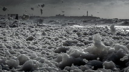 Dramatic Black and White Sea Foam and Cityscape