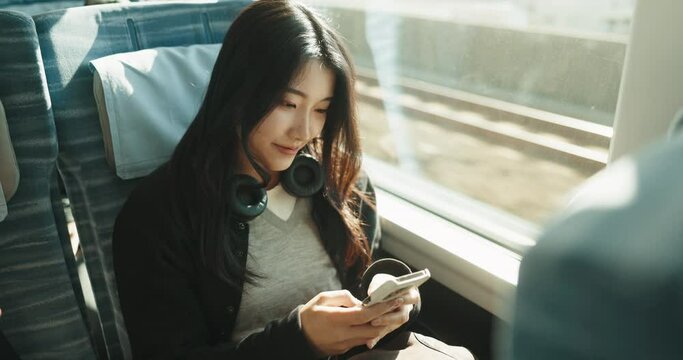 Train, Japanese woman and smartphone with typing, digital app and connection with adventure, journey and travel. Person, commute or girl with a cellphone, internet and communication with transport