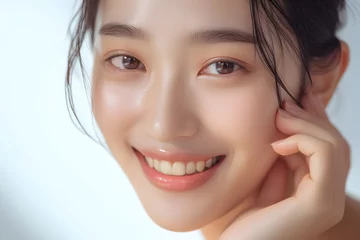 Fotobehang Closeup Beautiful smiling asian korean woman touch face with smooth healthy skin © Oksana