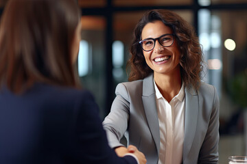 Happy mid aged business woman manager handshaking at office meeting. Smiling female hr hiring recruit at job interview, bank or insurance agent, lawyer making contract deal with client - obrazy, fototapety, plakaty