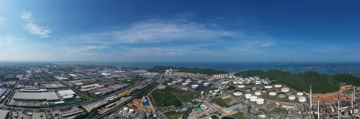 Aerial view of oil refinery or chemical factory and power plant with many storage tanks and pipelines. Business and petrochemical plants, oil storage tanks and for energy and steel pipes.