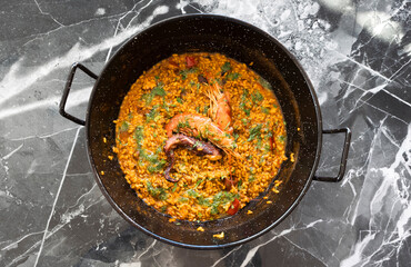 Traditional homemade paella inside the paella pot. Soup rice