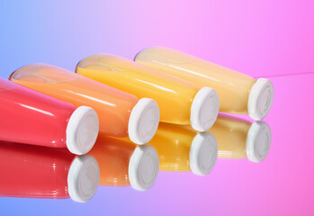 Glass bottles of juices lie on the surface. Drinks and bright spirits.