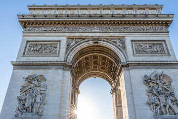 The arc de triumph during sunset with a sunstar