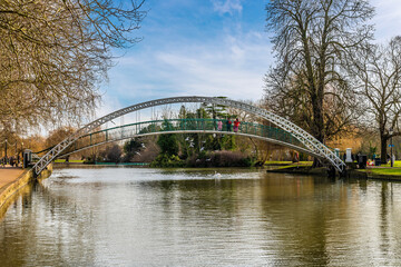 A view from the Embankment towards the suspension bridge over the River Great Ouse in Bedford, UK on a bright sunny day