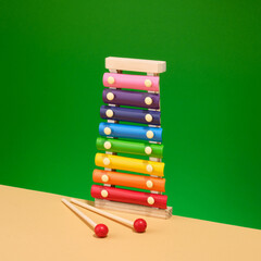 Bright colorful xylophone on a green background. Playground and childhood.