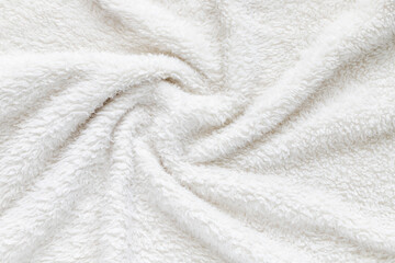 White soft plush fabric of cozy plush throw. Cozy blanket.