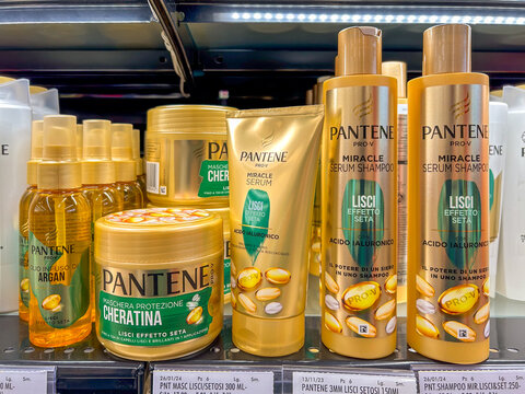 Italy - January 30, 2024: Pantene PRO-V hair care products, golden packs of shampoo and protective oil and cream displayed for sale on Italian supermarket shelves. Procter and Gamble brand