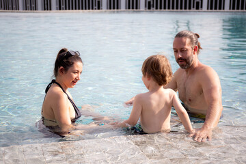 Caucasian family having enjoy and fun together with happiness in swimming pool, summer and holiday,...