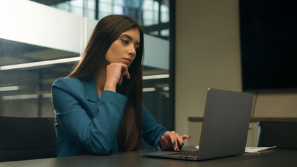 Thoughtful hesitate doubtful Indian woman work laptop in office pensive unsure puzzled Arabian girl choose compare idea decide female business manager computer think decision businesswoman thinking