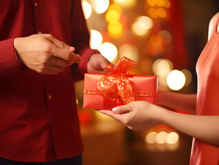 A family giving gifts and red envelopes to each other, Chinese New Year, blurred background, with copy space