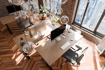 luxurious loft apartment with floor-to-ceiling windows and panoramic view; modern minimalistic interior design of workspace, top down view, home office area; bright daylight; 3D rendering