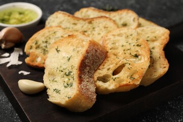 Tasty baguette with garlic and dill on table, closeup