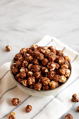 Homemade Chocolate Caramel Popcorn in a Bowl, side view. Copy space.