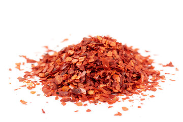 Pile of red chili pepper flakes isolated on white background