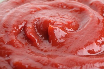 Tasty ketchup as background, closeup. Tomato sauce