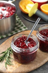 Fresh cranberry sauce in glass jars served on table