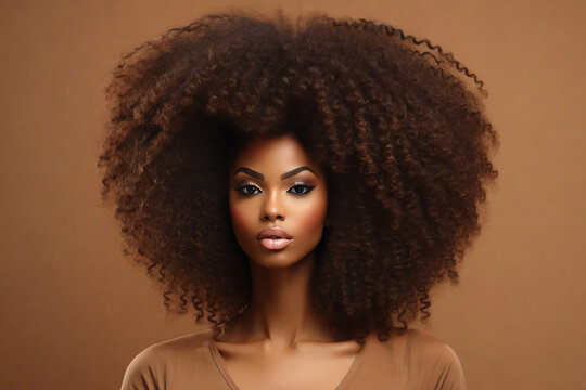 Beautiful African American woman with afro hairstyle on a beige background.