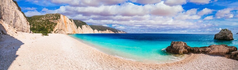 Greece best beaches of Ionian islands. Cephalonia (Kefalonia)- scenic desrted beach Fteris with tropical turquoise sea and white pebbles - 724008353