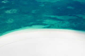 Drone view of white sandy beach in the green ocean, minimalist photo and copy space, summer...