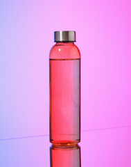 A bottle with a drink in it. Juice or mineral water.