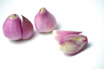 peeled fresh red onion sliced isolated on a white background, close up view