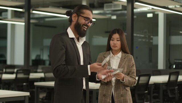 Inequality money equal business financial profits finance injustice sad poor Asian Korean woman hold little money envy look at happy rich Indian Arabian colleague counting many cash discrimination