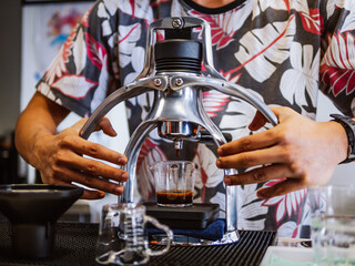 Barista use manual process to make espresso with classic espresso machine. Rok Manual Espresso Maker Hand Craft