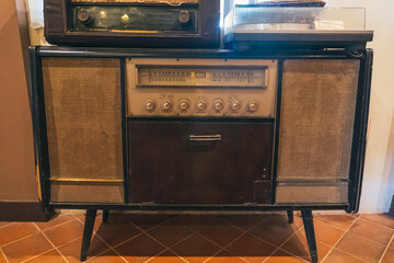 Ancient radio lay on the shelves. Radio on cabinet next to plant. Real photo. retro radio. antique...