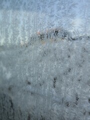 Ice crystals formations on glass car window.