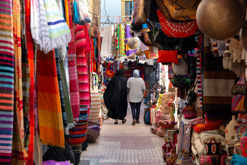 Two women walking around the souk in Essaouira, Morocco