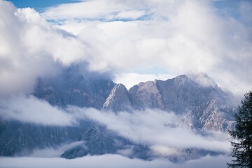 Fototapeta na wymiar Dolomites Mountains covered in clouds in autumn season. Italy