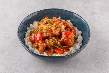 Chicken with rice in sweet and sour sauce on a stone background, studio shooting 1