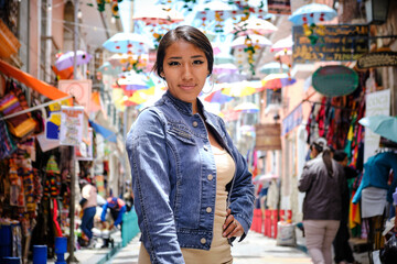 beautiful young latin woman strolling through the colorful and touristic streets of la paz bolivia - travel concept