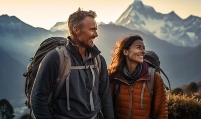Photo sur Plexiglas Himalaya Couple hiker traveling, walking in Himalayas under sunset light.