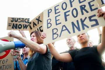 People protest financial crisis on the streets. Crowd marching for global inflation economy