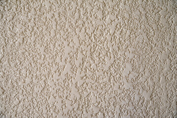 Decorative beige facade plaster with relief texture