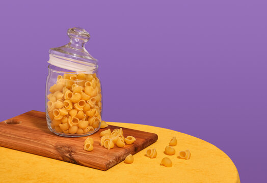 Pasta and a wooden kitchen board. Copy space for text.