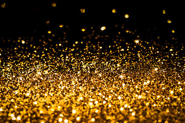 Gold glitter on black background.