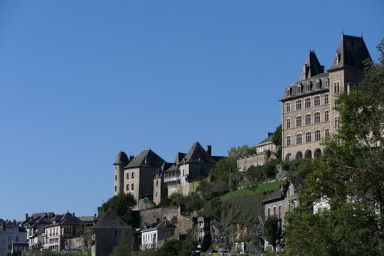 Uzerche, a picturesque French city, graces the hillside with its timeless charm during the summer. The city view reveals a tapestry of old buildings adorned with architectural elegance.