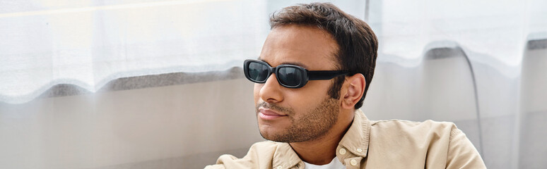 handsome indian man with visual impairment in everyday comfy outfit wearing glasses, banner