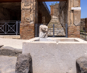 Fountain for public use on one of the streets of ancient city, Pompeii, Naples, Italy