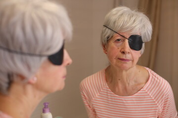 Senior woman wearing a black eyepatch
